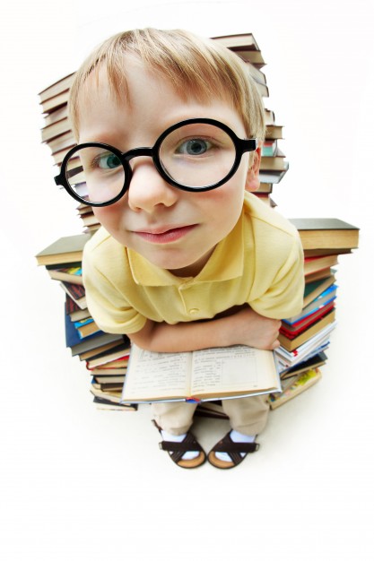 little-boy-with-glasses-surrounded-by-books_1098-2099