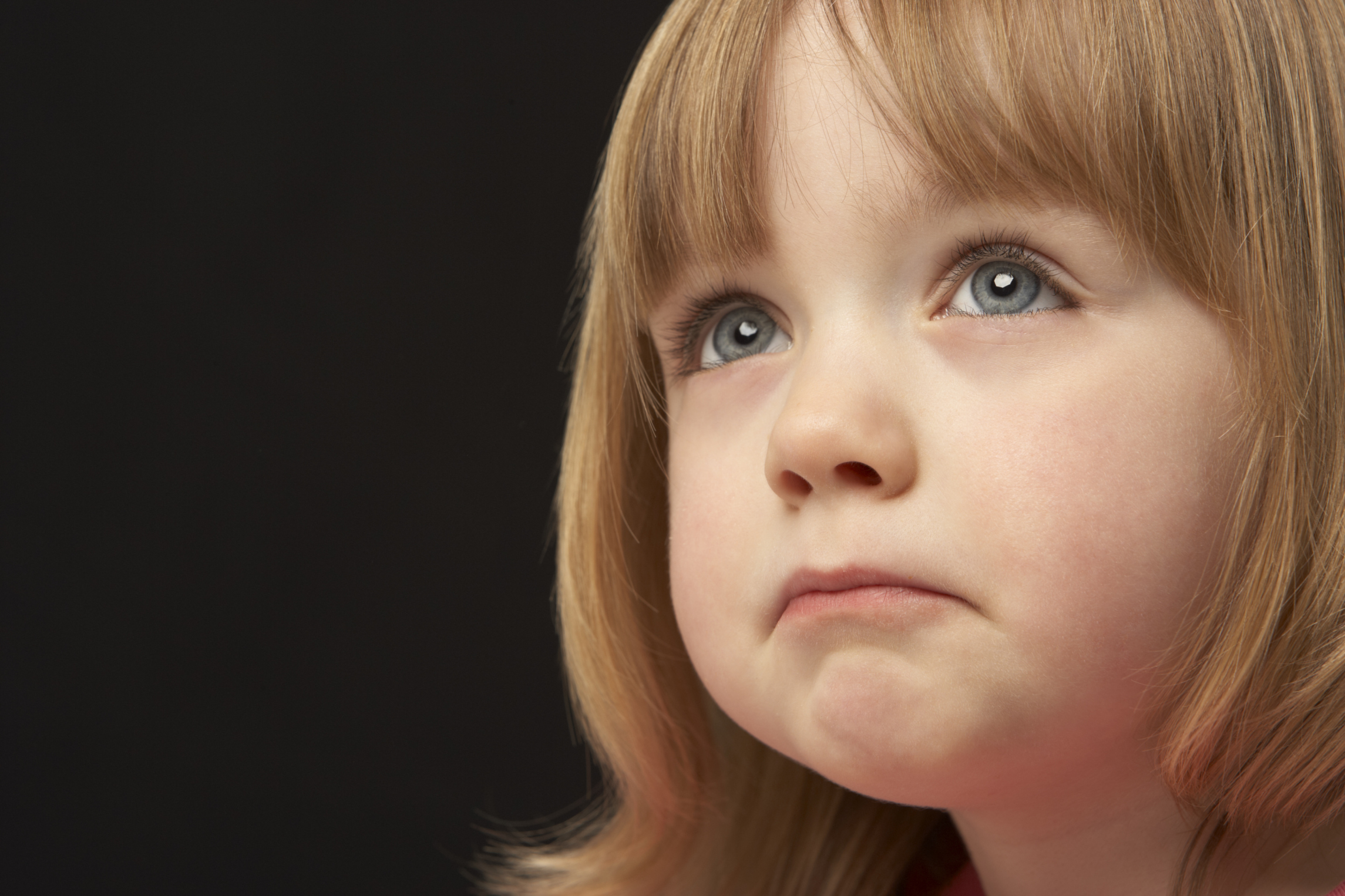 Close Up Studio Portrait Of Sad Young Girl